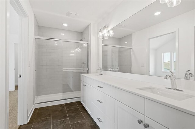 bathroom featuring dual bowl vanity, walk in shower, and tile patterned floors