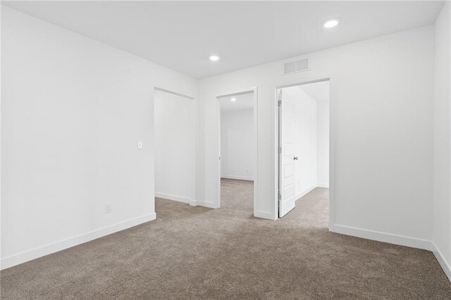 empty room featuring light carpet