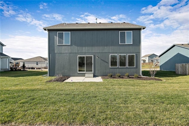 rear view of house featuring a lawn and a patio area