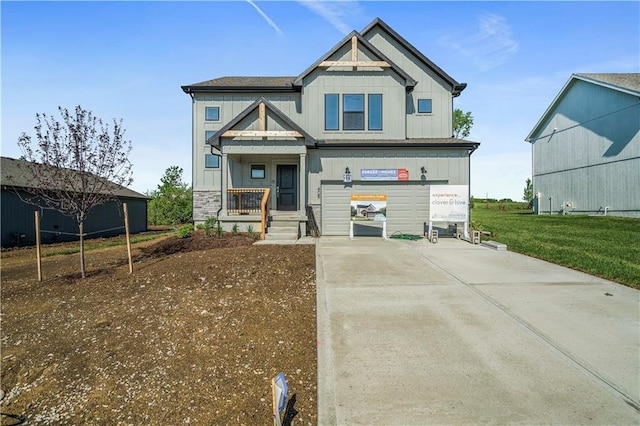 408 Woodview Dr, Raymore, MO 64083 - view of front facade featuring driveway, board and batten siding, covered porch, and a garage
