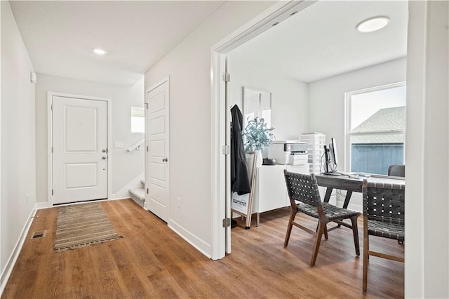408 Woodview Dr, Raymore, MO 64083 - hallway with wood finished floors, baseboards, stairway, and recessed lighting