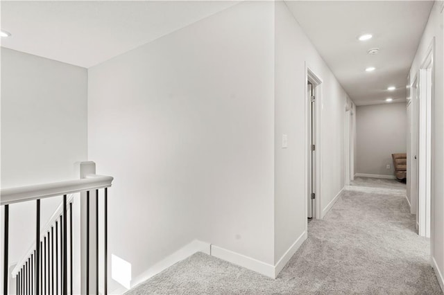 408 Woodview Dr, Raymore, MO 64083 - corridor with light carpet, an upstairs landing, recessed lighting, and baseboards