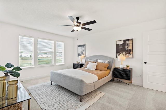 408 Woodview Dr, Raymore, MO 64083 - bedroom featuring light carpet, baseboards, and ceiling fan