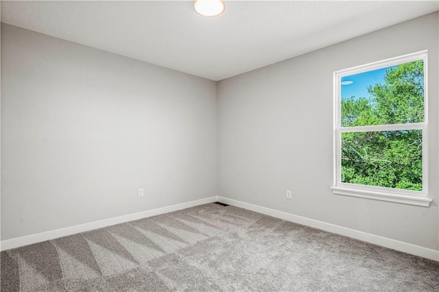 408 Woodview Dr, Raymore, MO 64083 - spare room with carpet and baseboards