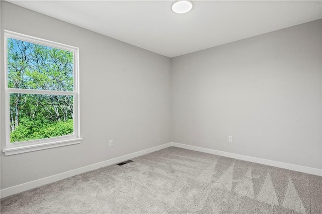 408 Woodview Dr, Raymore, MO 64083 - carpeted spare room featuring baseboards
