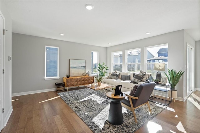 living area with recessed lighting, baseboards, and wood finished floors