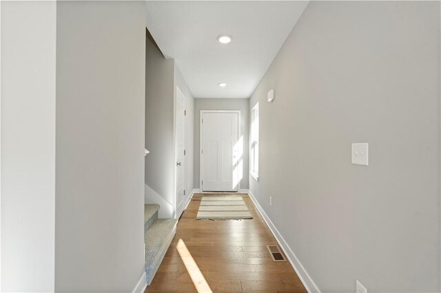 hallway with wood-type flooring