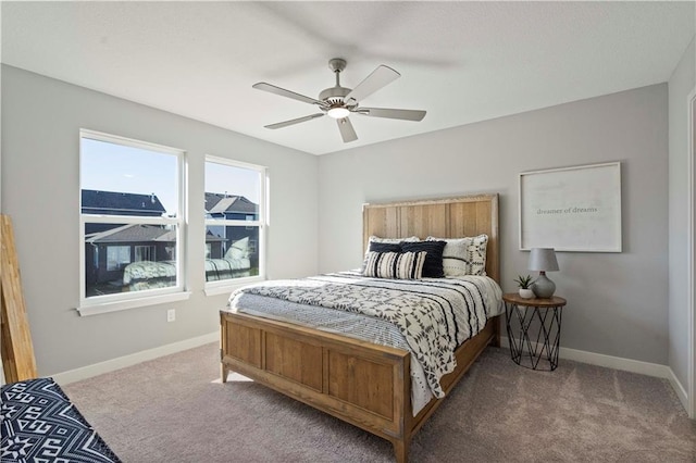 bedroom with ceiling fan, carpet floors, and baseboards