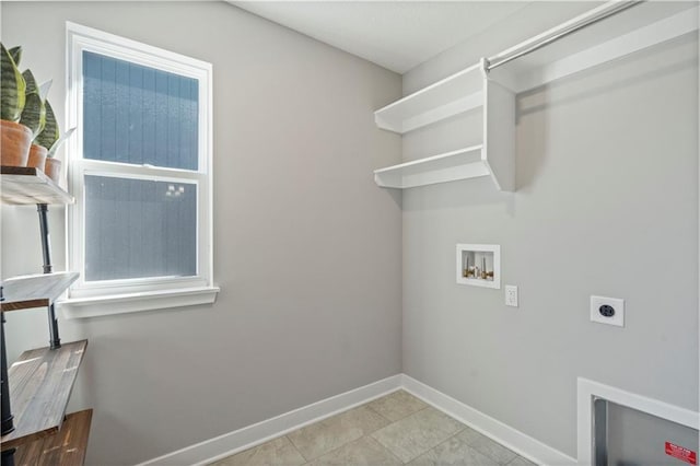 clothes washing area with laundry area, baseboards, tile patterned floors, hookup for a washing machine, and electric dryer hookup