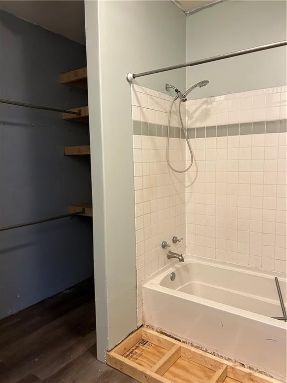 bathroom featuring tiled shower / bath combo and hardwood / wood-style floors