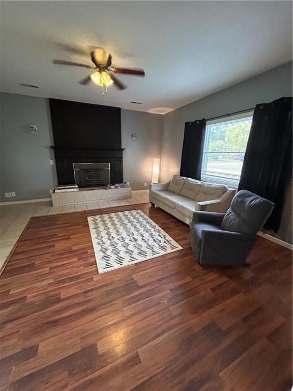 living room featuring wood-type flooring and ceiling fan