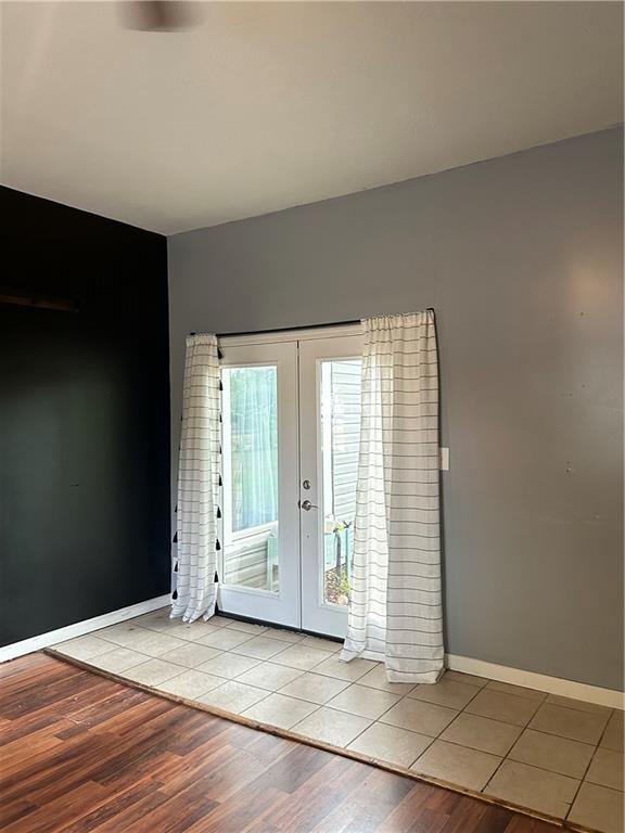 doorway featuring light hardwood / wood-style flooring, a healthy amount of sunlight, and french doors