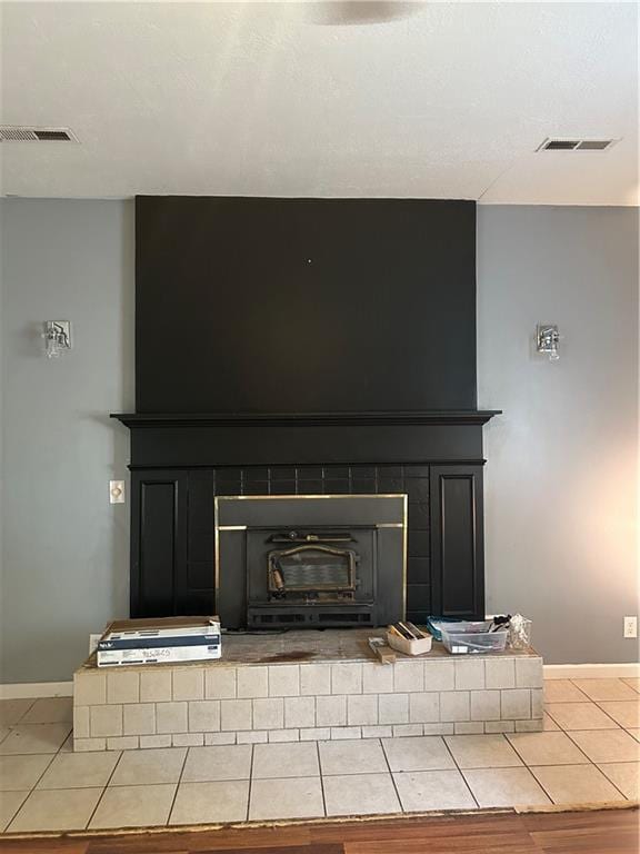 interior details with a brick fireplace and hardwood / wood-style floors