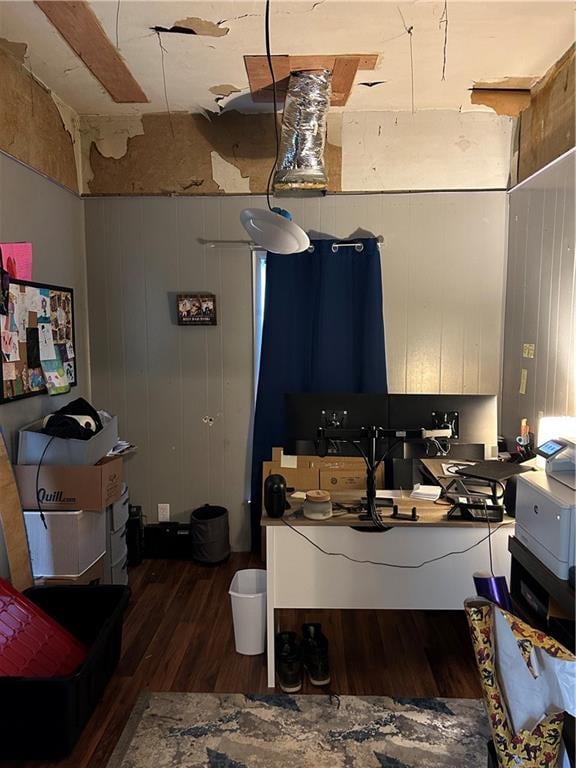 office area featuring dark hardwood / wood-style floors and wooden walls