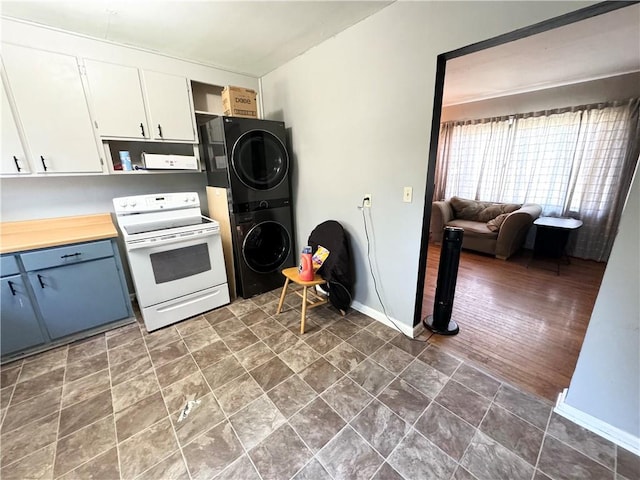 kitchen with white cabinets, white electric range, blue cabinets, stacked washer / drying machine, and dark hardwood / wood-style flooring