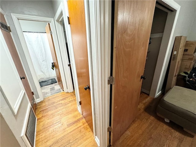 corridor with light hardwood / wood-style floors