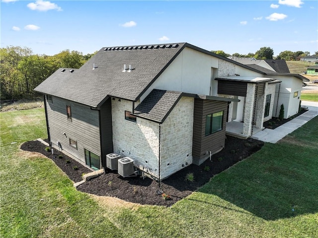 view of home's exterior with a yard and central air condition unit