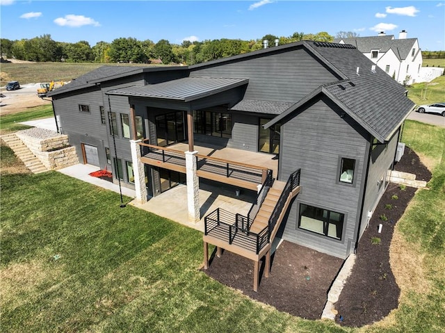 rear view of house with a lawn and a patio area