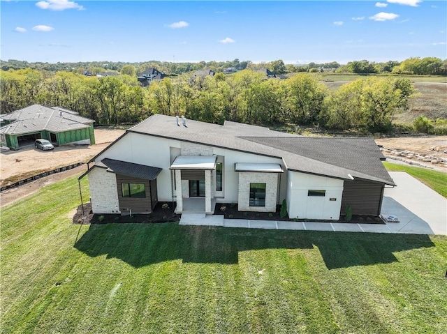 rear view of property with a lawn