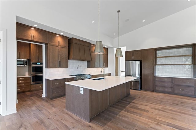 kitchen featuring custom range hood, sink, stainless steel appliances, and dark hardwood / wood-style flooring