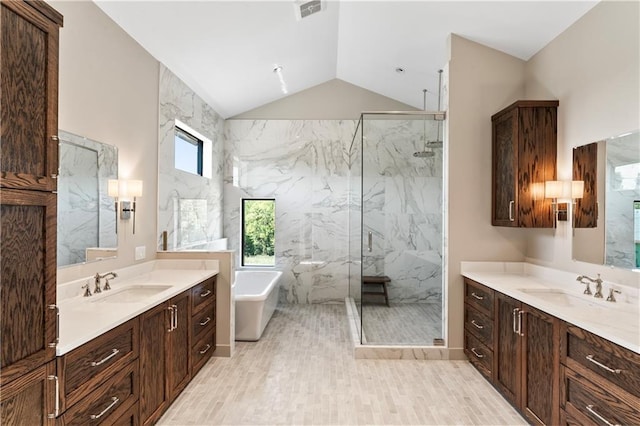 bathroom featuring hardwood / wood-style floors, lofted ceiling, vanity, and shower with separate bathtub