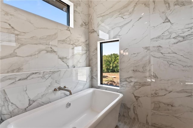 bathroom with a skylight and a bath