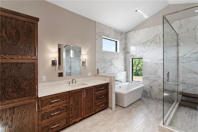 bathroom featuring vanity, shower with separate bathtub, vaulted ceiling, and a wealth of natural light