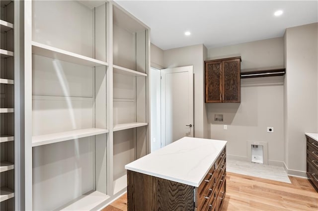 spacious closet with light hardwood / wood-style flooring