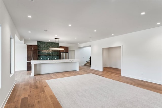 unfurnished living room with light wood-type flooring