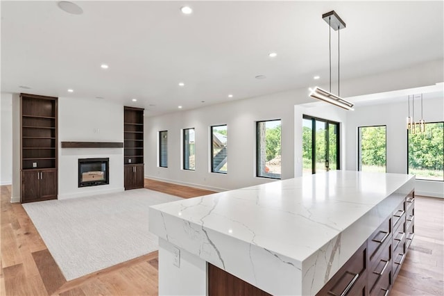 kitchen featuring plenty of natural light, hanging light fixtures, and a large island