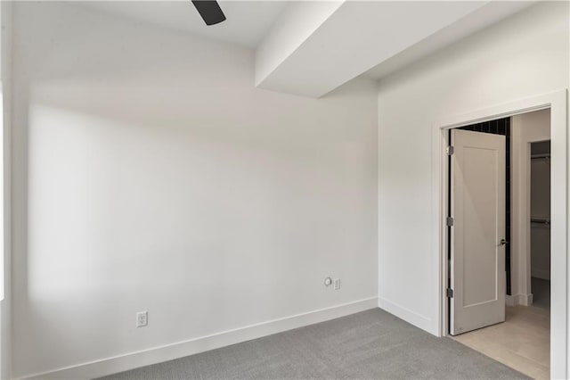 unfurnished room with ceiling fan and light colored carpet