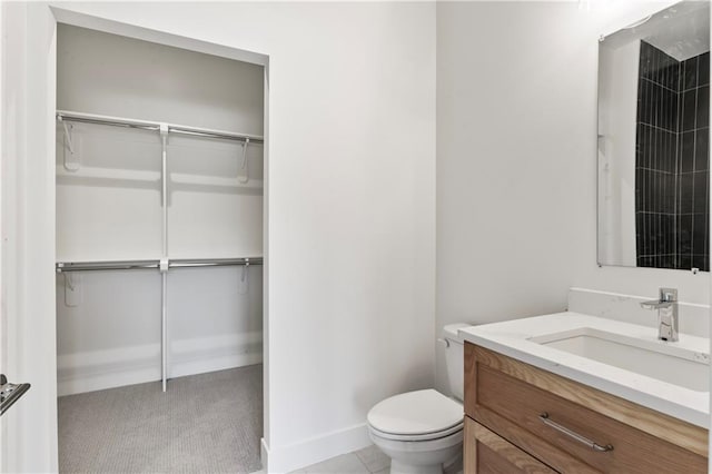 bathroom with vanity, tile patterned flooring, and toilet