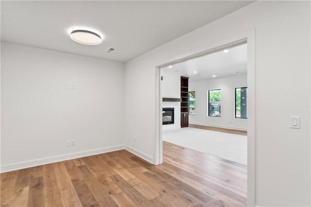 unfurnished room with wood-type flooring