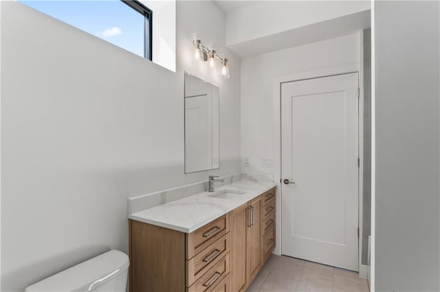 bathroom with vanity, tile patterned flooring, and toilet