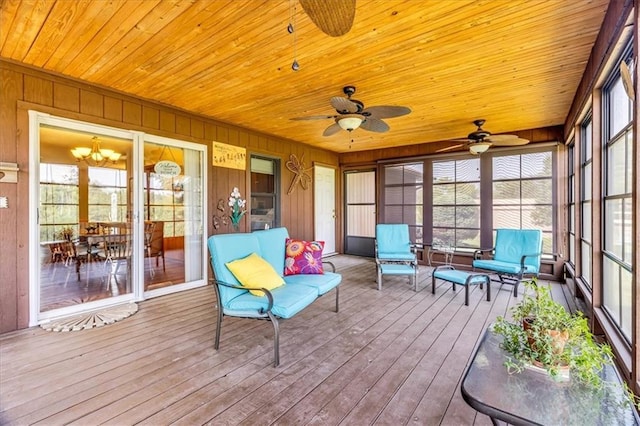 sunroom / solarium featuring wooden ceiling and ceiling fan with notable chandelier