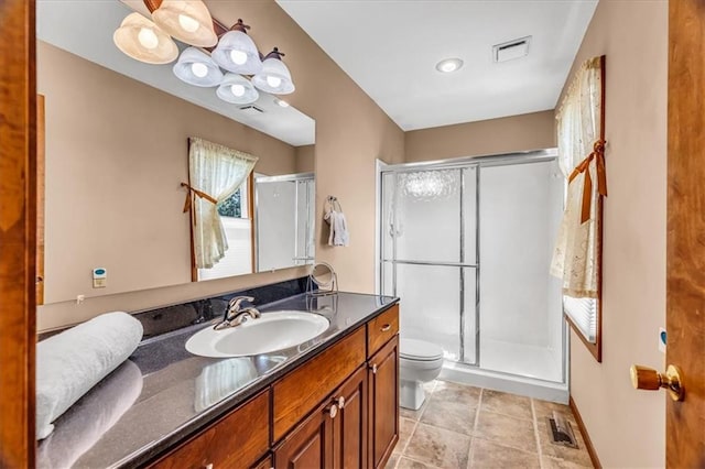 bathroom with walk in shower, vanity, and toilet