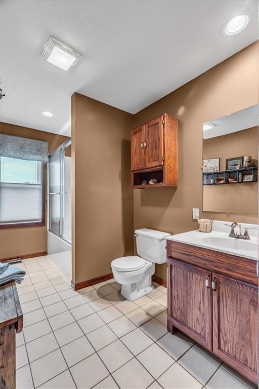 bathroom with tile patterned flooring, vanity, and toilet