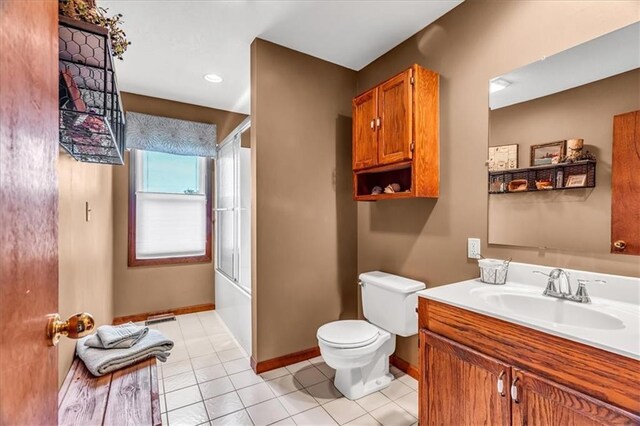 full bathroom with tile patterned flooring, vanity, toilet, and bath / shower combo with glass door