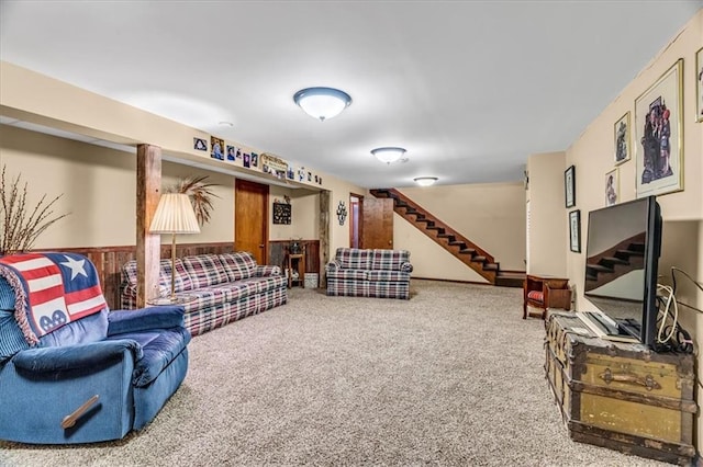 carpeted living room featuring stairway and wainscoting