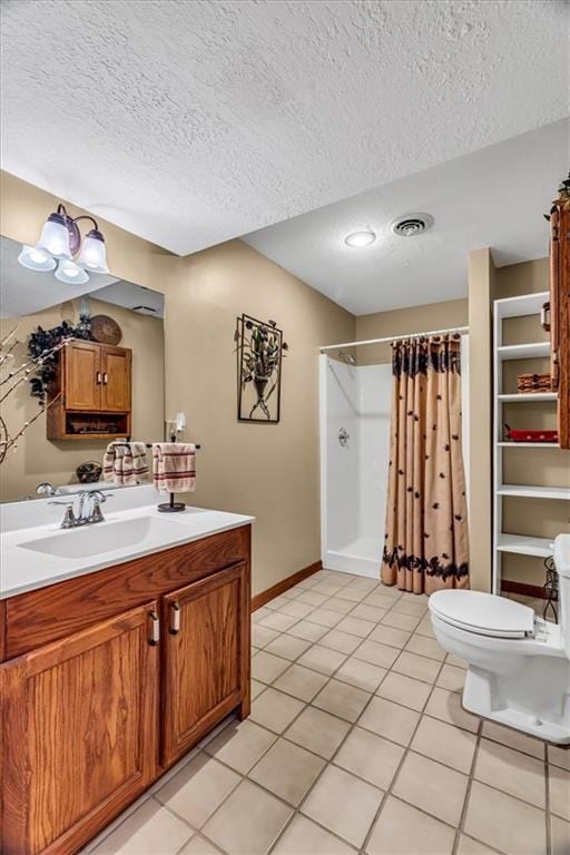 bathroom with vanity, toilet, curtained shower, a textured ceiling, and tile patterned flooring