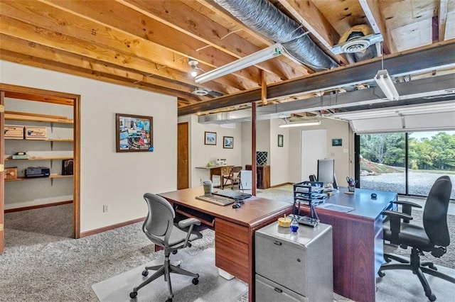 office area featuring light carpet and baseboards