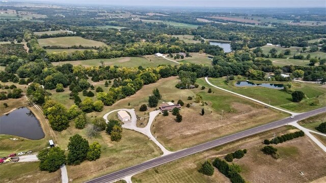 drone / aerial view featuring a water view and a rural view