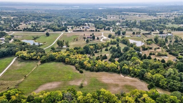 drone / aerial view featuring a water view and a rural view