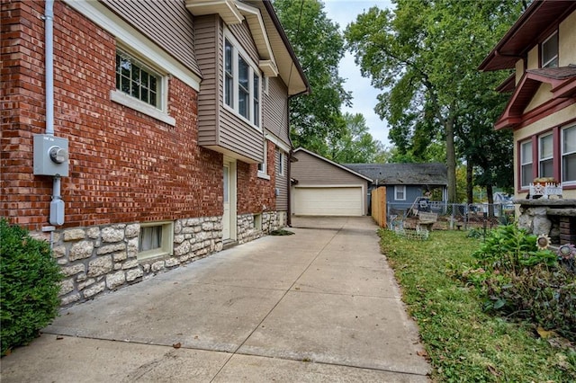 view of property exterior with a garage and an outbuilding