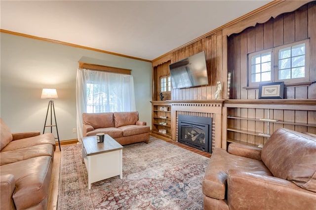 living room with wood-type flooring, ornamental molding, and plenty of natural light