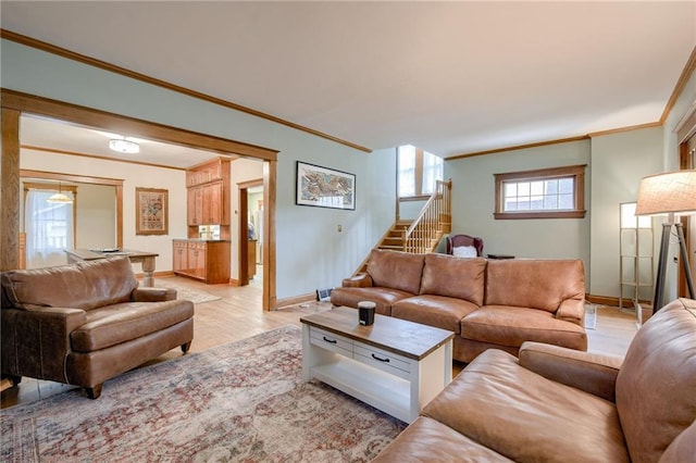 living room with crown molding and light hardwood / wood-style floors