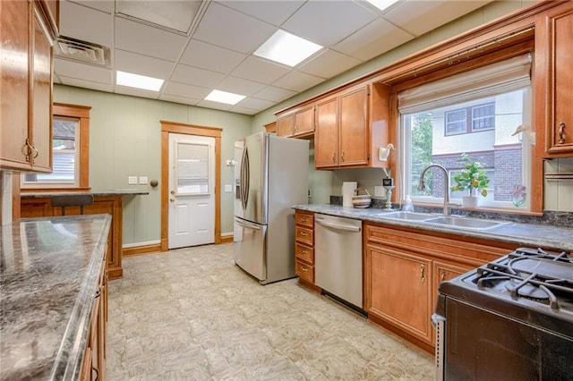 kitchen featuring a drop ceiling, stainless steel appliances, and sink