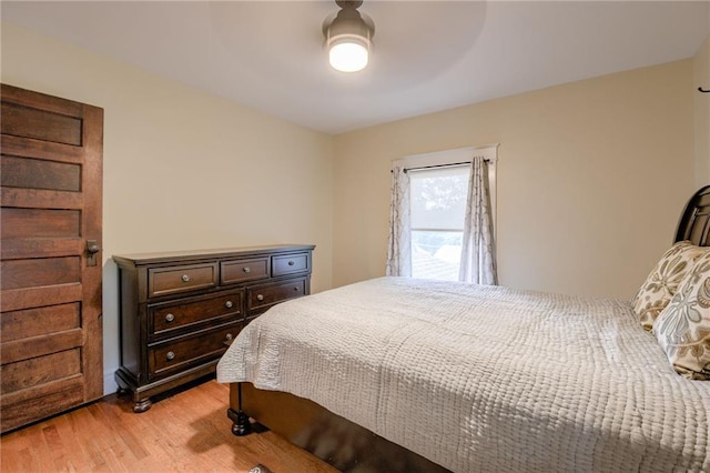 bedroom with light hardwood / wood-style floors and ceiling fan