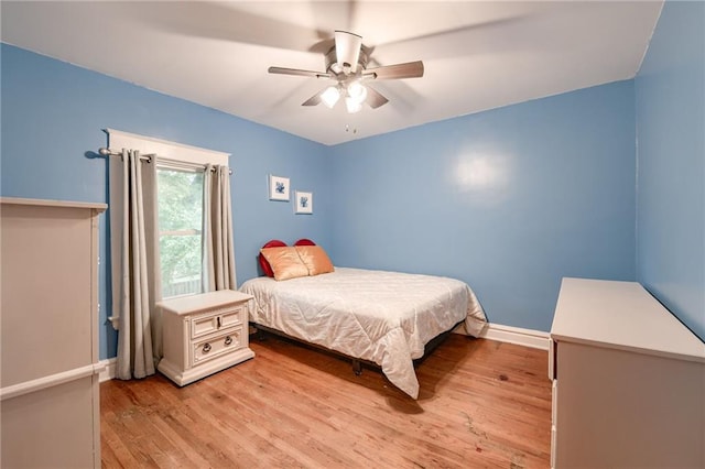 bedroom with light hardwood / wood-style floors and ceiling fan