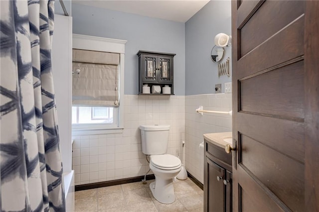 bathroom featuring tile walls, tile patterned floors, vanity, and toilet